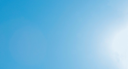 The brilliance of a sparkling blue sky lit by the sun in a spring day as a decorative background