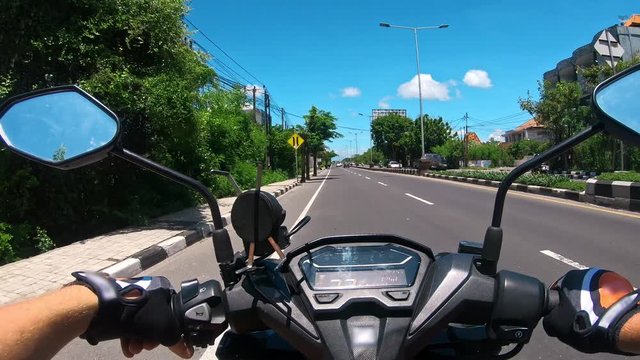 Riding a motorcycle on a paved road in the first person