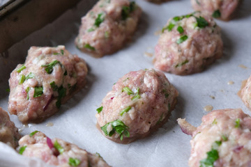 Uncooked raw healthy meat balls ready to be cooked on the oven.