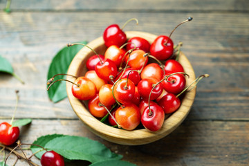 sweet cherries on a wooden background