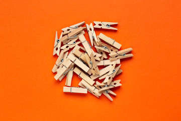 wooden clothespins on an orange background