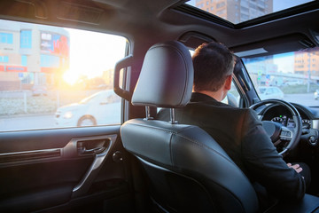 man driving a new car