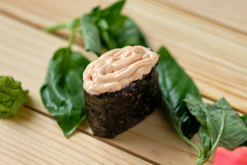 sushi with sauce and basil