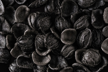handmade pasta scattered on a gray stone table