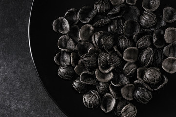 handmade pasta scattered on a gray stone table