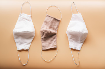 homemade cloth masks for protection against coronavirus (COVID-19) on brown background medium shot