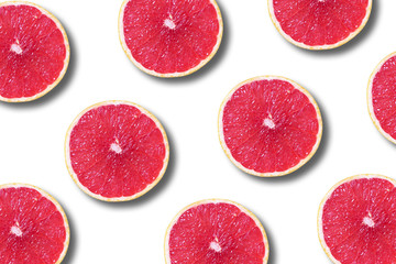 Grapefruit pattern on white background. Top view. Creative design, minimal flat lay concept. Summer time. Tropical travel, exotic fruit. Vegan and vegetarian food