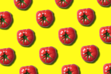 Red tomato pattern on trendy yellow background with copy space. Top view. Flat lay. Creative packing design. Summer minimal concept. Vegan and vegetarian diet
