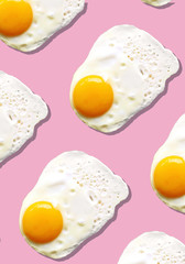 Fried egg or scrambled eggs pattern on pink background. Creative food concept. Top view. Conceptual trend. Banner. Keto diet. Healthy food print. Creative design for packaging.