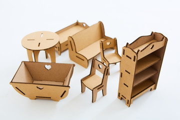 Dollhouse furniture from cardboard. Concept of Circular economy.