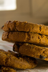 a column of oatmeal cookies with chocolate on the table