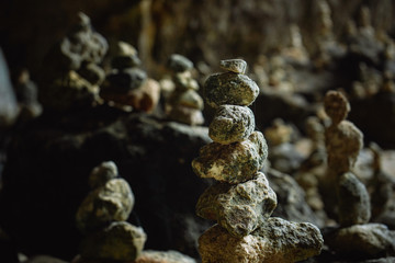 Balancing stones tower on mossy stone background