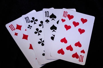 a deck of playing cards on a black background.