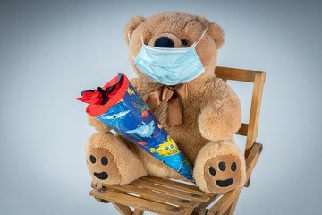 A teddy bear with respiratory mask and a school cone