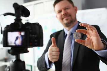 Business trainer hold silver bitcoin in hand