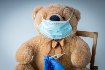 A teddy bear with respiratory mask