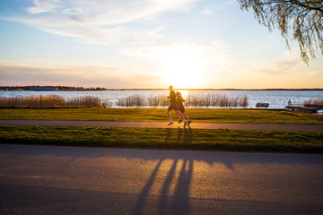 Couple running in the sunset by the lake