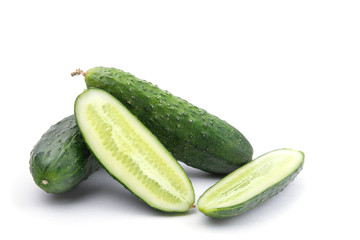 cucumbers whole and cut on a white isolated background close-up