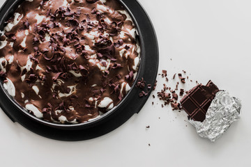 Homemade marble cake  with dark chocolate bar on white background. Top view. Vegetarian dessert.
