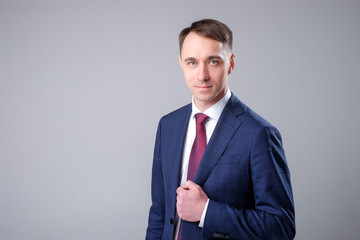 man in a business suit on a plain background