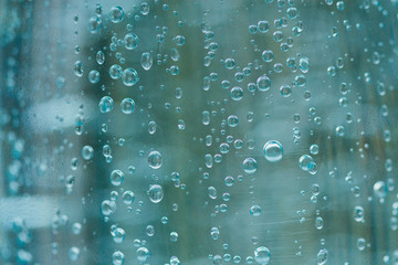 Macro of oxygen bubbles in plastic bottle of mineral water. Selective focus on center with shallow depth of field