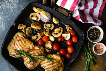 Grilled chicken and vegetable on stone background