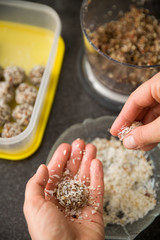 The girl is preparing sweet treats. Protein Chocolate Balls. Healthy sweets. Organic raw treats from nuts, coconut, dates and cocoa