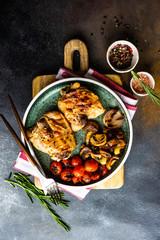 Grilled chicken and vegetable on stone background