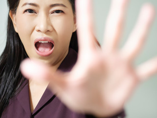 Business asian women are scared and show hand sign to tell five things. Lady was decline and ban communication. Idea concept make business failed. Stop to do behavior before your health is bad.