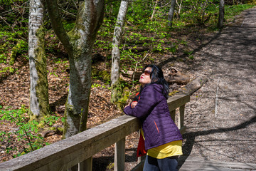 A woman is delighted to enjoy the fresh air in a forest in Scania, south Sweden