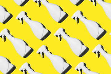 White plastic bottle of cleaning product, household chemicals or liquid laundry detergent on yellow background. Creative design for packaging. Top view. Flat lay. Copy space. Detergent bottle