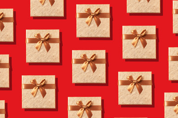 Gift box with sparkling gold glitter on red background. Romantic card. Creative design for packaging. New year, Christmas, Valentine's day concept of greetings. Copy text. Top view, flat lay.