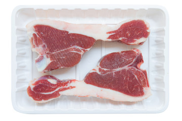 raw lamb loin chop cut on plastic tray isolated on white background