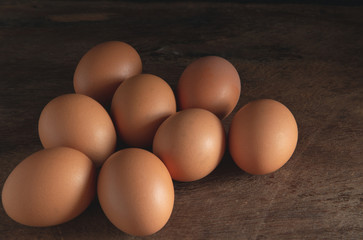 chicken eggs on wooden table background, eggs with copy space concept.
