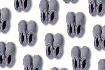 Pattern of grey ugg boots on white background. Creative design for packaging. Winter concept. Christmas and new year holiday.