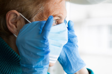 Naklejka premium portrait of senior woman with disposable medical mask. Safety in public places during coronavirus outbreak.