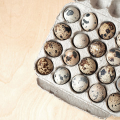 Quail eggs on white wooden table.
