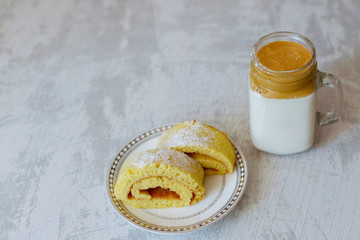 dalgona coffee and homemade biscuit on a light marble background