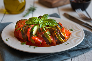 Homemade ratatouille made with sliced vegetables: zucchini, tomatoes and eggplant. Delicious vegan dish