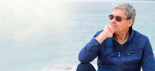 portrait of older man looking at the sea