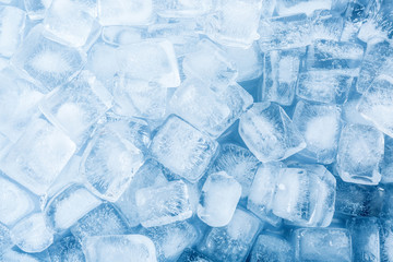 Crystal clear ice cubes as background, top view