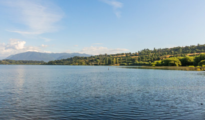 Serene panorama of the calm waters of Panguipulli Lake, from the village of Panguipulli. Patagonian area, Chile.