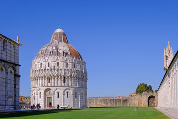 Obraz premium The baptistery at the Piazza Dei Miracoli with the famous Leaning Tower and the dome, Pisa, Tuscany, Italy