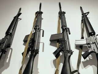 guns standing on a shelf. home exhibition of weapons, collective storage