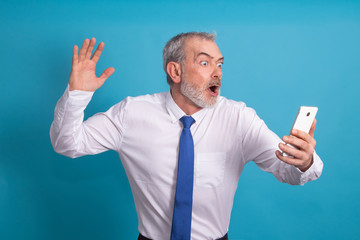 amazed isolated business adult man looking at mobile phone