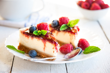 Homemade delicious cheesecake with fresh fruit and mint