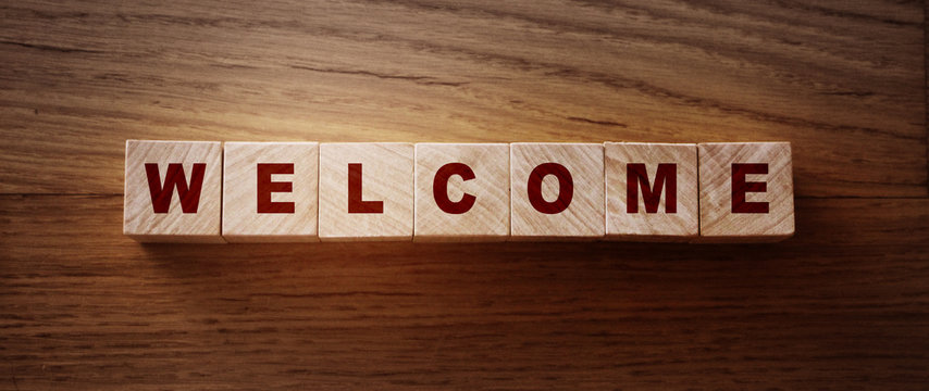 Wooden Blocks with the text Welcome. Congradulation newcomers concept