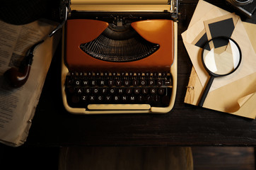 Flat lay composition with vintage detective items on dark wooden background