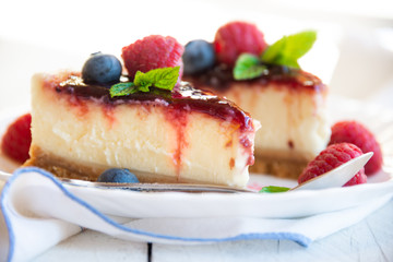 Homemade delicious cheesecake with fresh fruit and mint