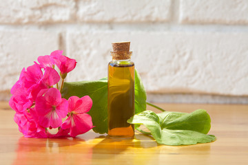 Essence of flowers on table in beautiful glass jar